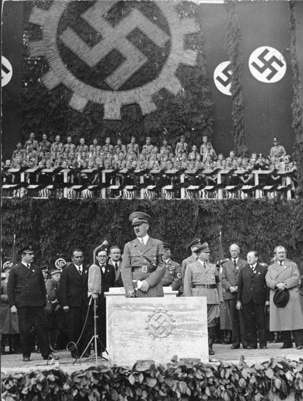 Adolf Hitler bei der Grundsteinlegung des Volkswagenwerks am 26. Mai 1938; rechts im Vordergrund Ferdinand Porsche.